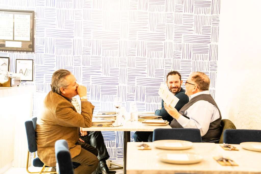 Guests enjoying conversation at Anhelo Bistro