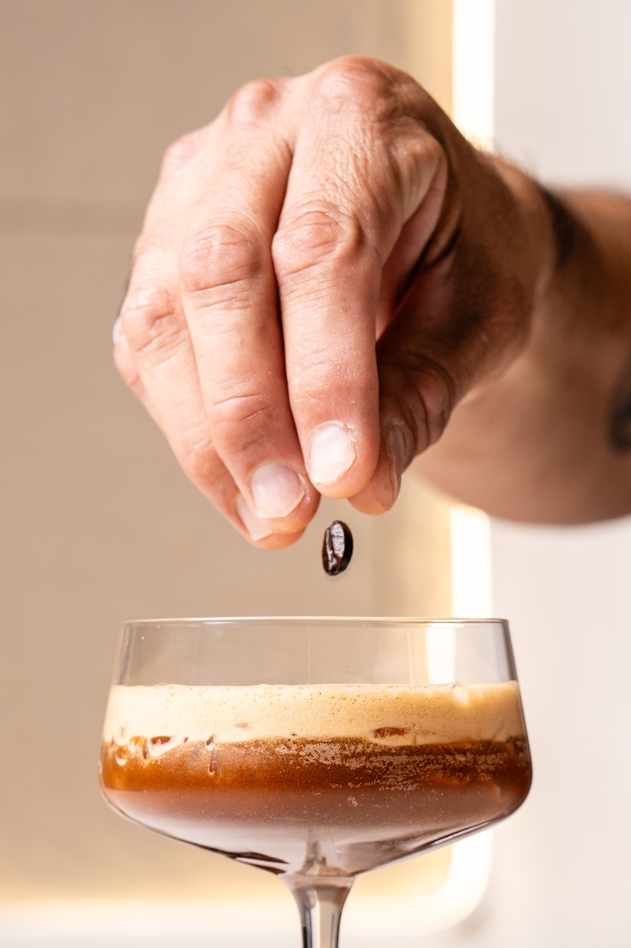 Coffee bean dropped over espresso martini