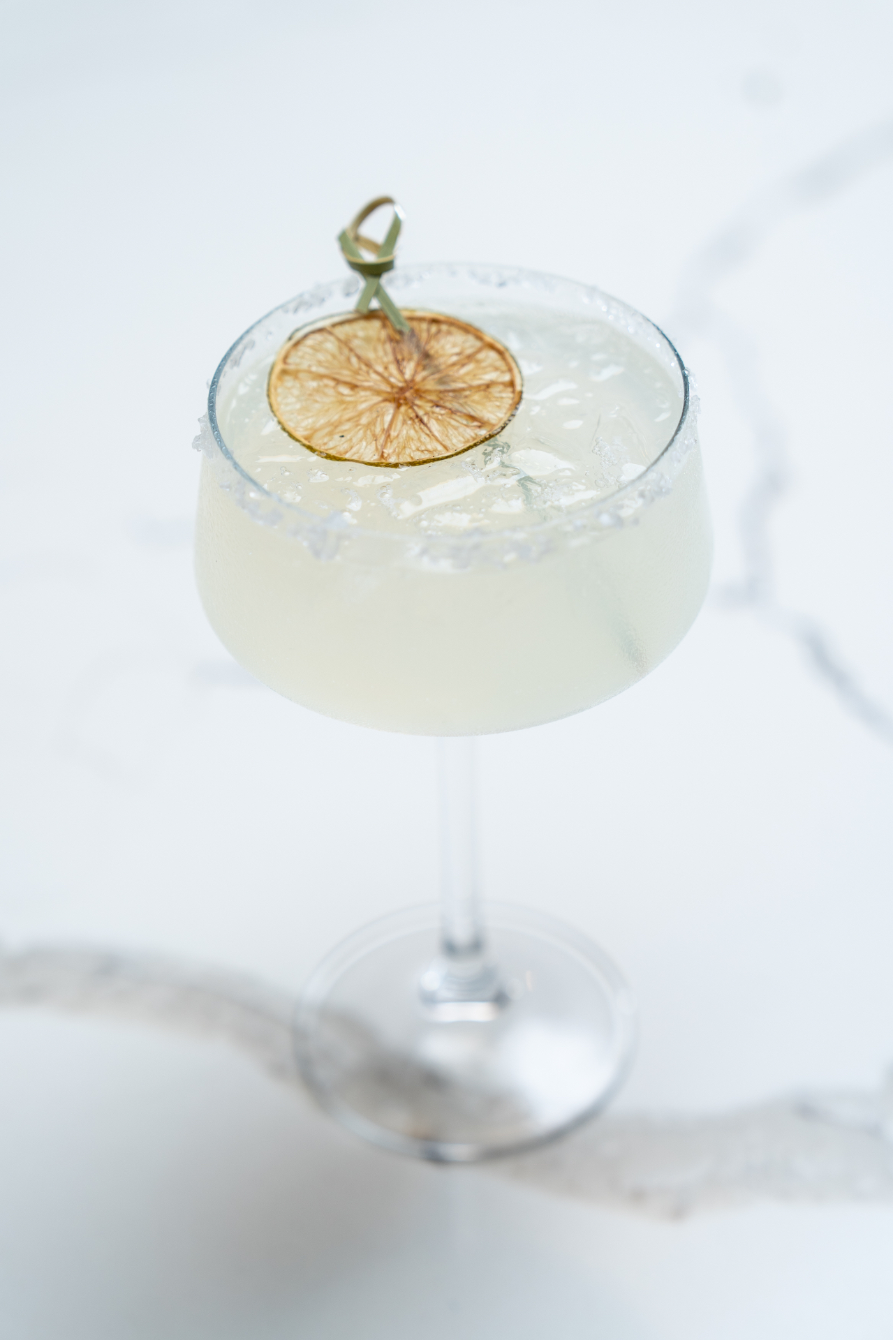 Classic margarita with salted rim and dried lime