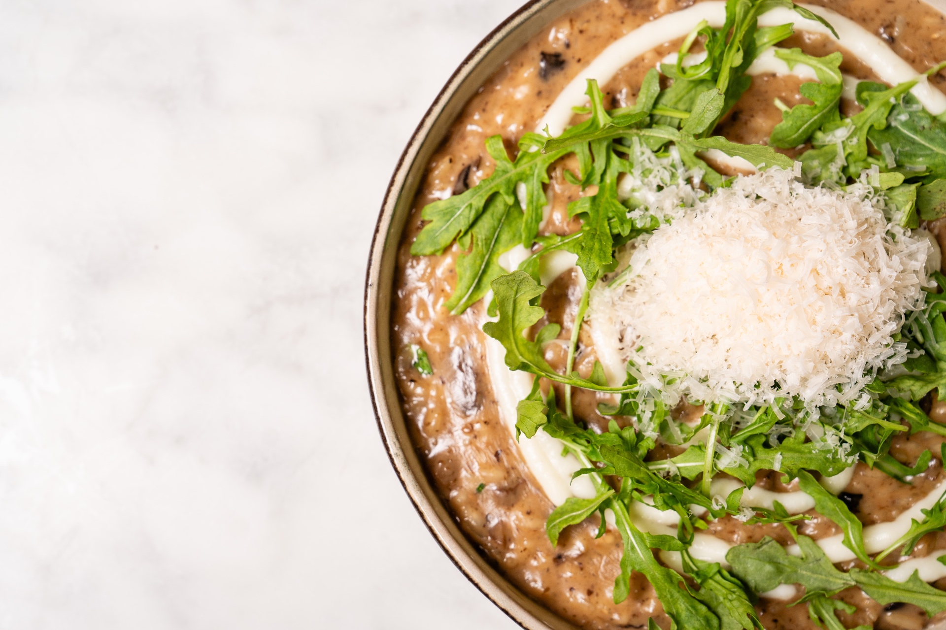Creamy mushroom risotto with arugula and parmesan