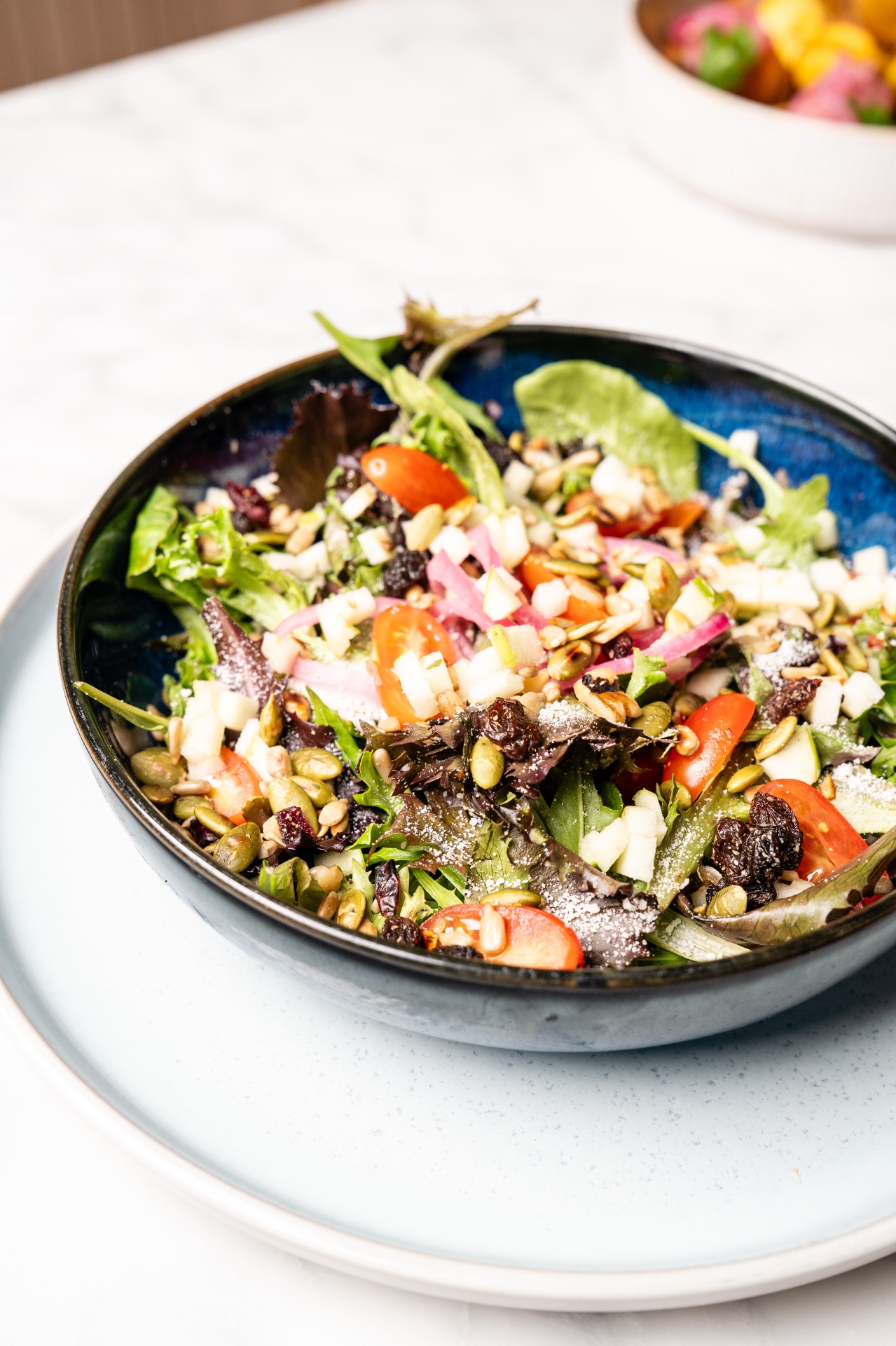 House garden salad with seeds and cherry tomatoes