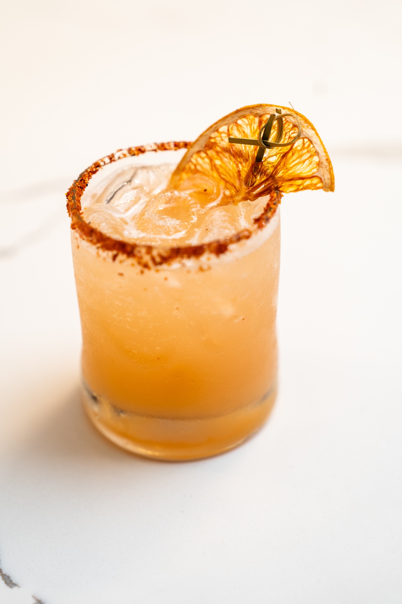 Spicy margarita with chili rim and dried orange